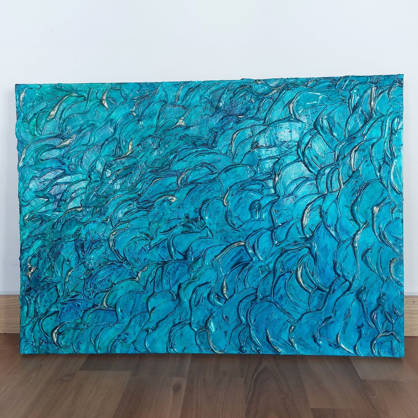 Heavily textured aqua blue painting on canvas