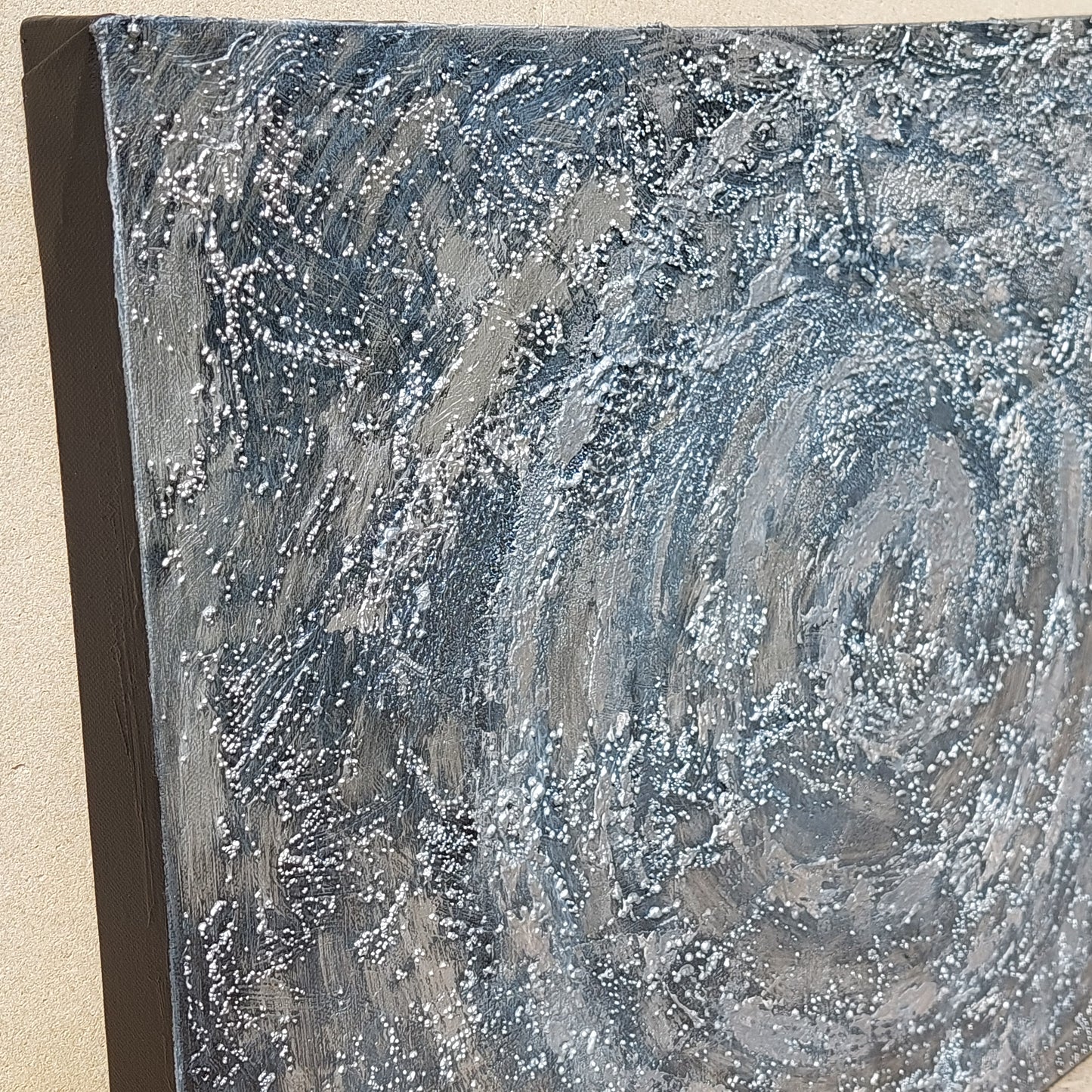 Close up detail of silver & grey textured acrylic painting.