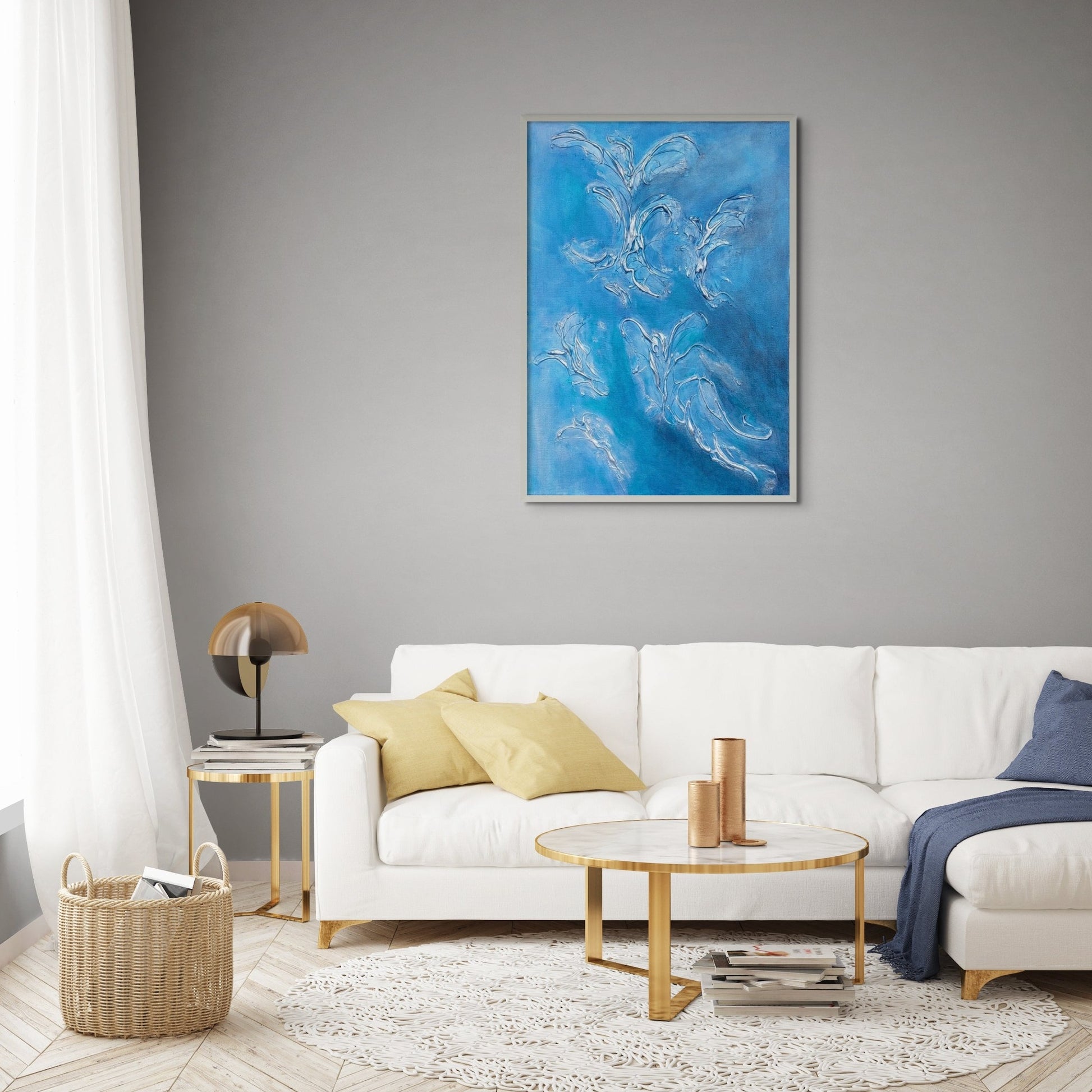 blue acrylic and texture painting hanging above white sofa