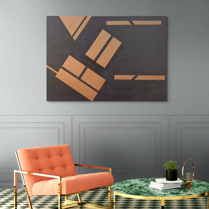 Copper and black canvas art hanging above peach and gold chair